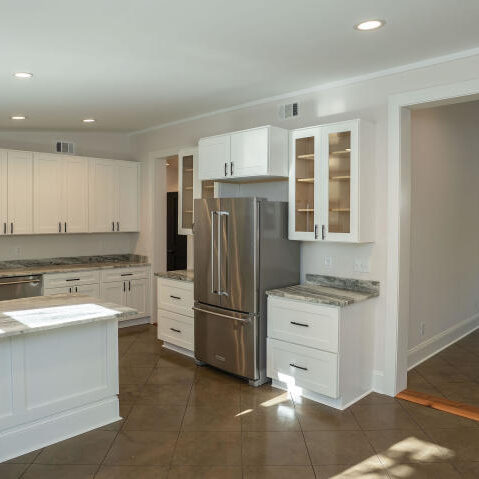 Kitchen over looking into Living area